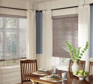 Tan roman shades in the kitchen nook of a home in Albany done by Curtain & Carpet Concepts