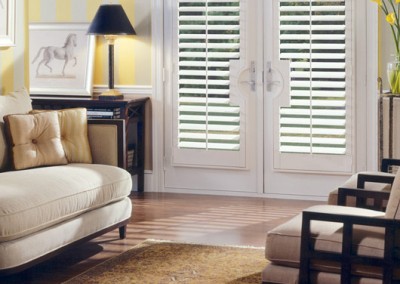 Interior plantation shutters and area rug in the living room of a home in Saratoga Springs NY